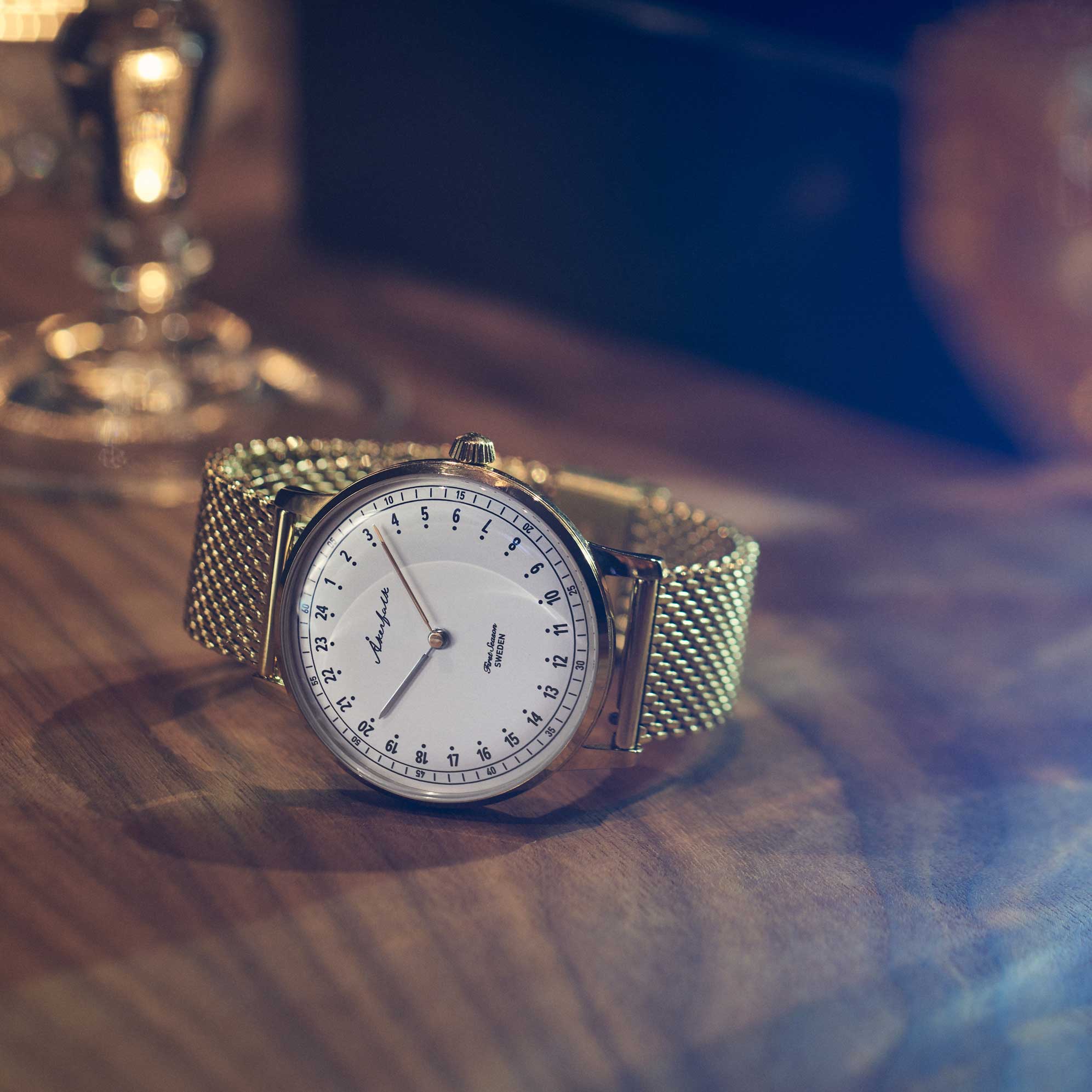 24-hour watch with gold case and gold mesh strap